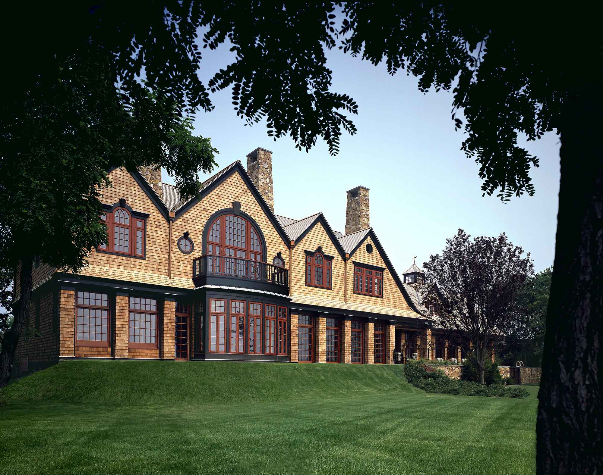 Shingle style, North Shore, Long Island, rear yard, balcony, red windows, stone chimney, slate roof Asharoken