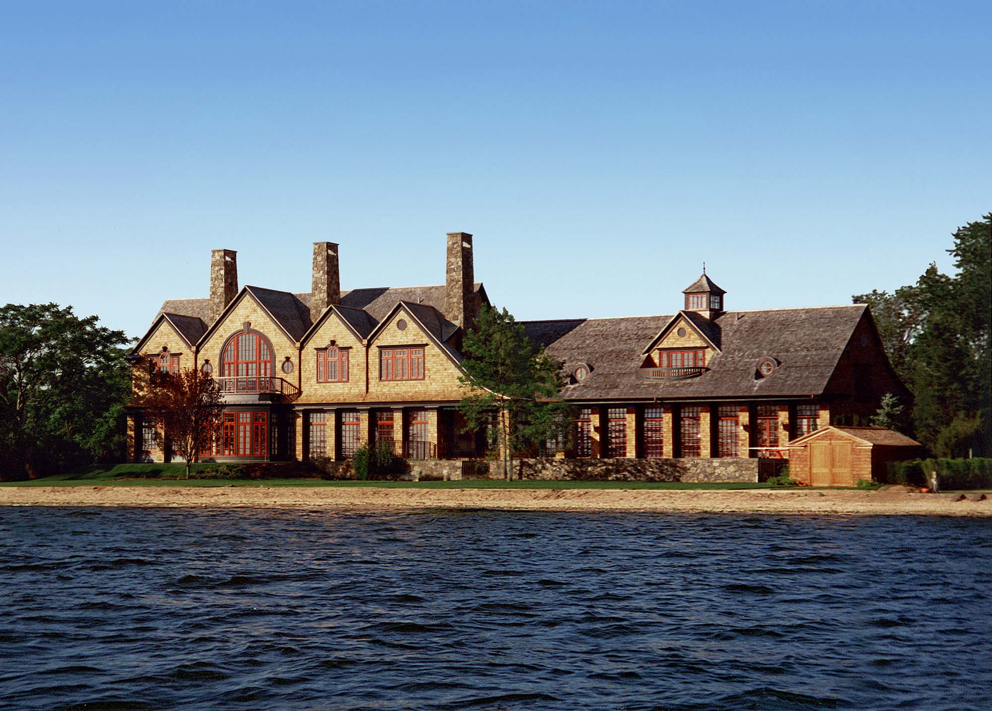 Shingle style, North Shore, Long Island, rear yard, balcony, red windows, stone chimney, slate roof, water beach